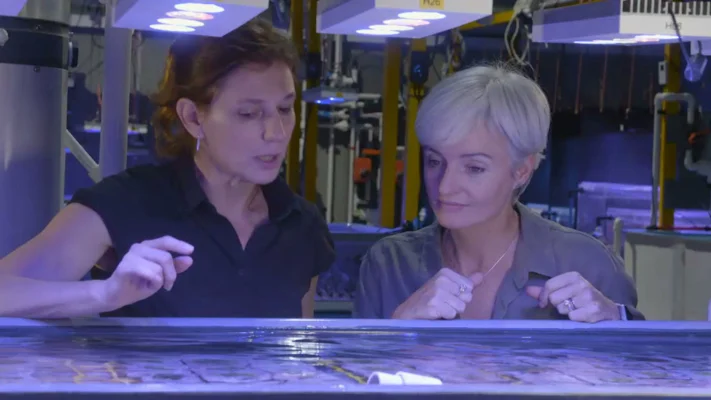 Can We Save the Reef? Host Prof Emma Johnston (right) and Dr Madeleine van Oppen (left) examine the coral-rearing tanks at Sea Sim, Australian Institute for Marine Science, Townsville.