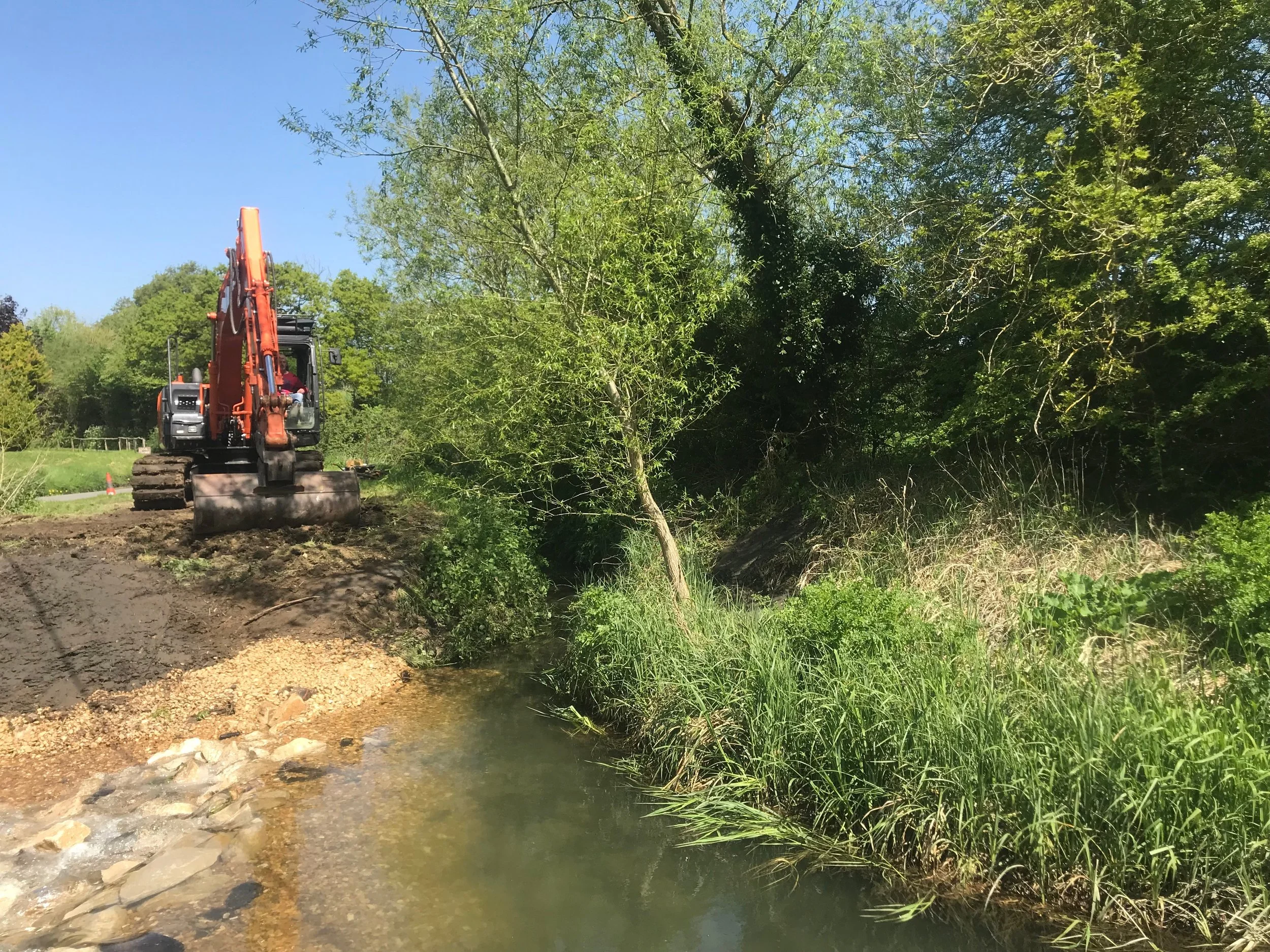 An excavator was used to introduce limestone boulders and gravel to form the new nature like rock ramp fish passage easement.