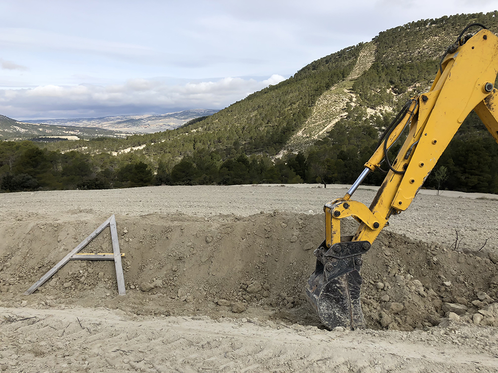 checking the accuracy of the contoured excavation with the A frame...