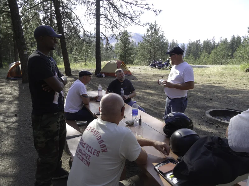 The guys begin to arrive and relax after long rides for all.