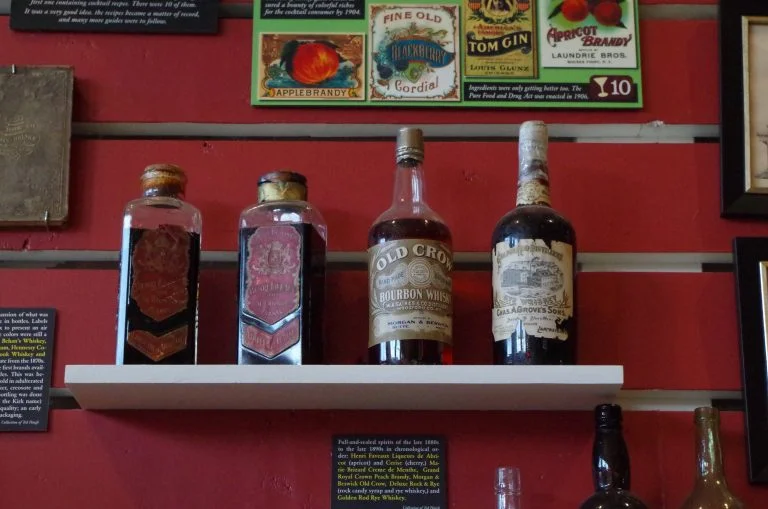 antique bourbon bottles at the Museum of the American Cocktail