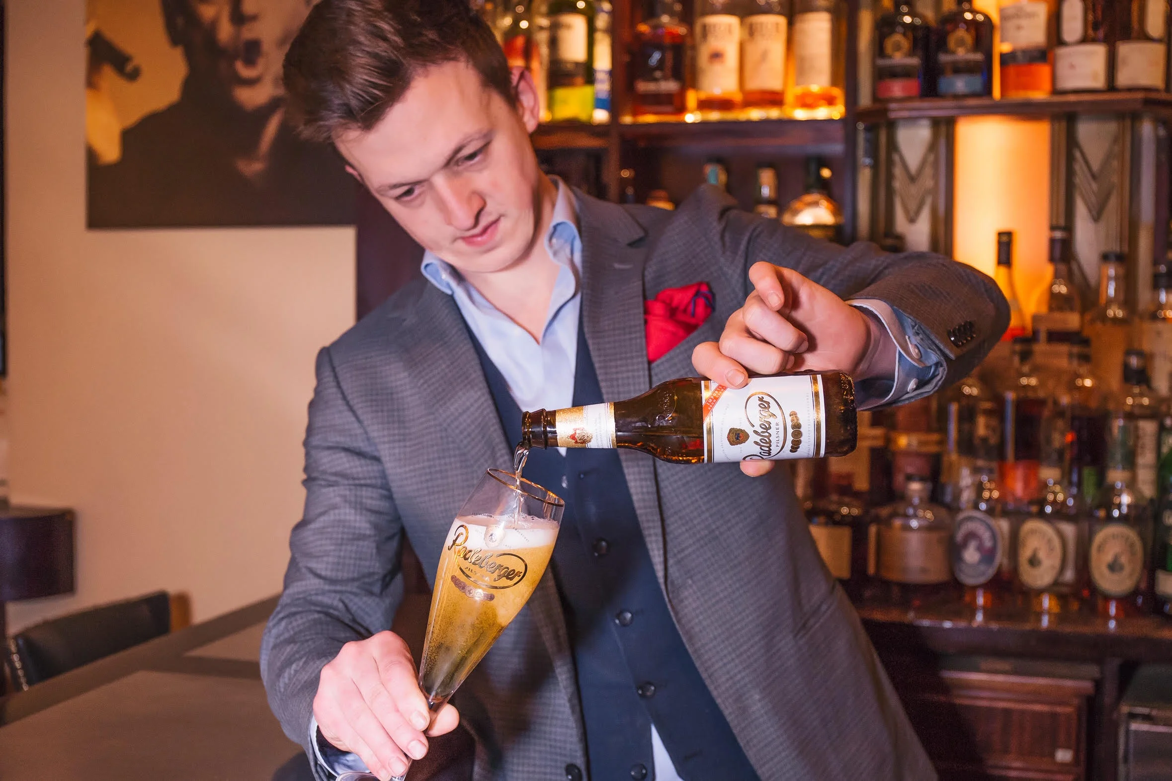 Jared Bailey pours Radeberger at SoHo Cigar Bar, photo by Margaret Pattillo photography