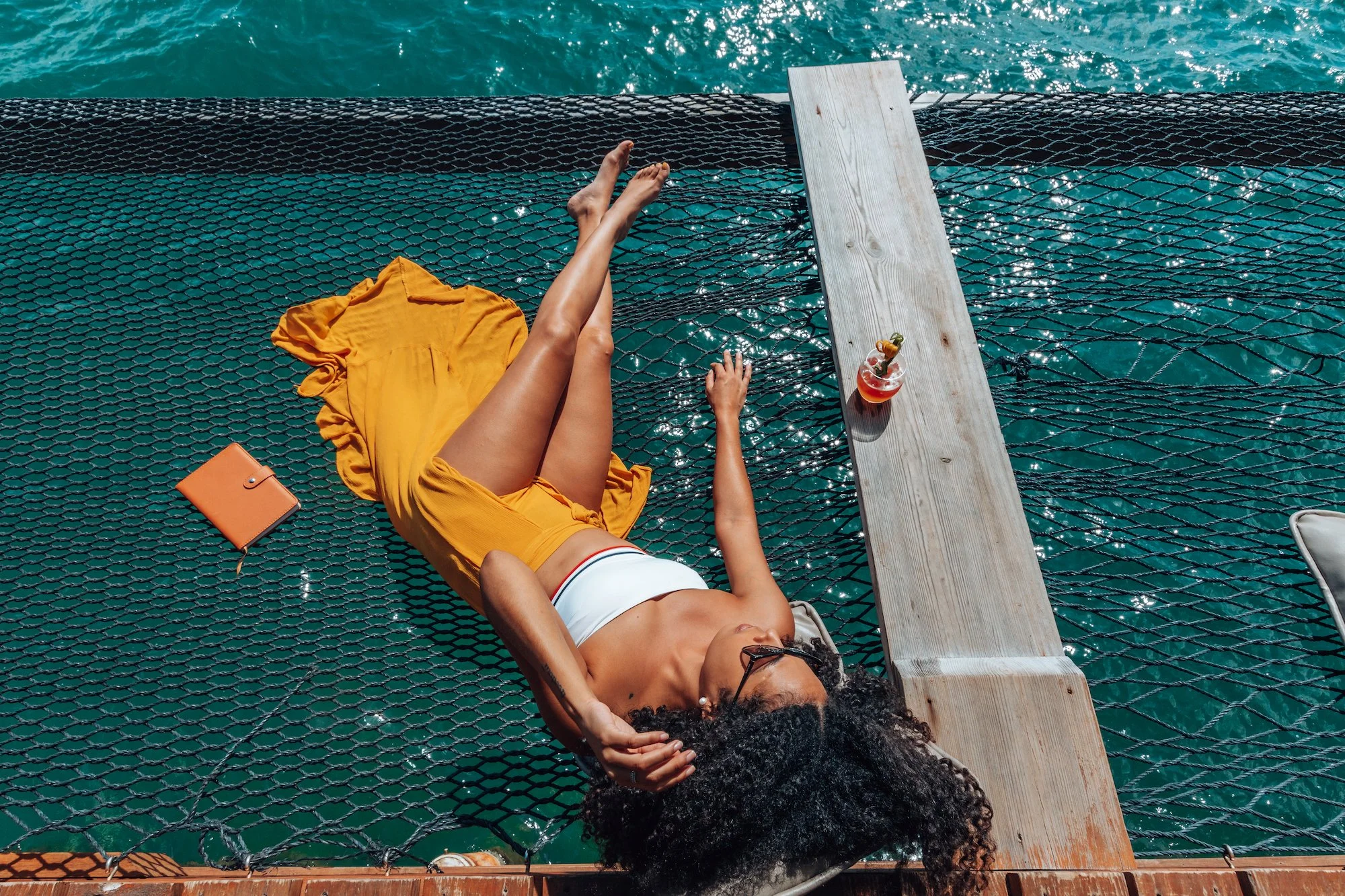 A daybed suspended over the water at Big Dock Bar.