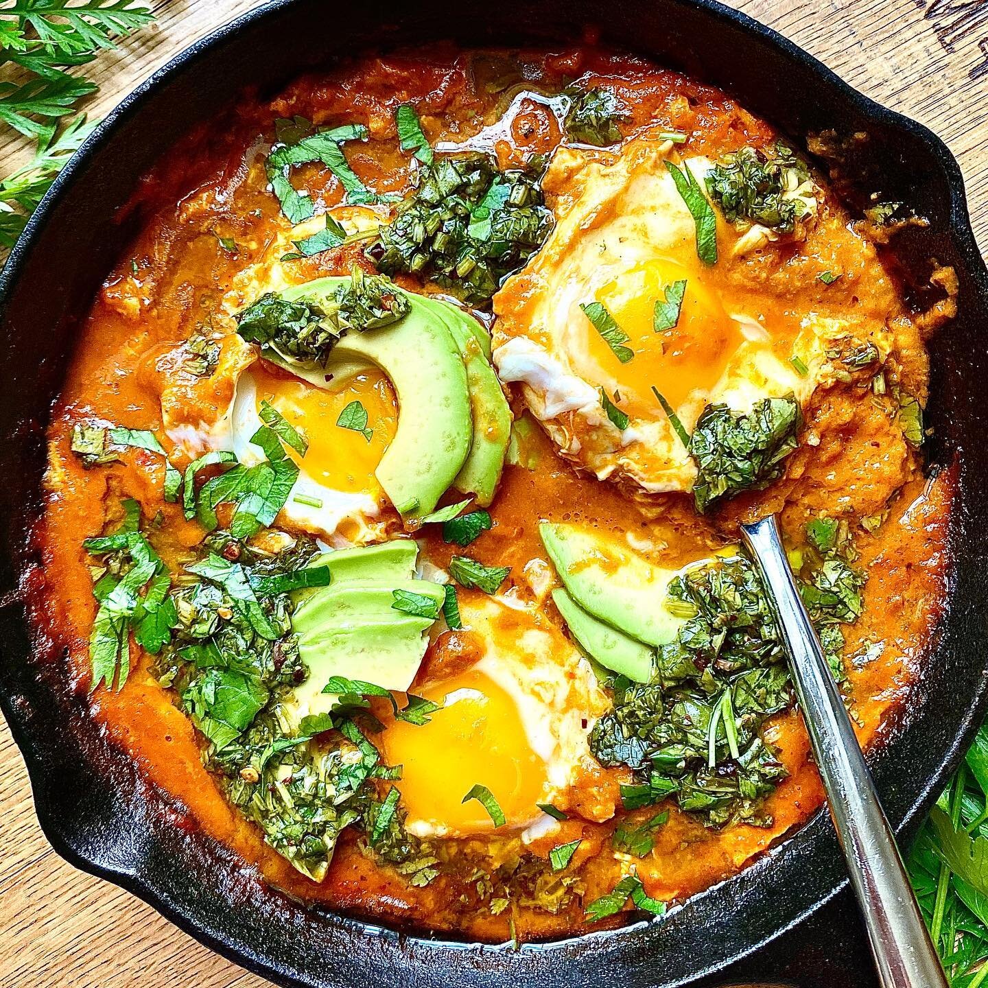 A #shashuka inspired dish made of some leftovers in our fridge - roasted pepper and tomato soup that I had made a little too spicy, salsa verde I made for some fish earlier this week made of carrot tops and herbs on the verge, and a little sliced avo