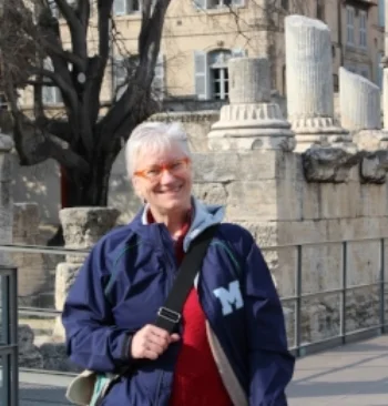 Madame Tesson smiles proudly in a Marymount windbreaker.