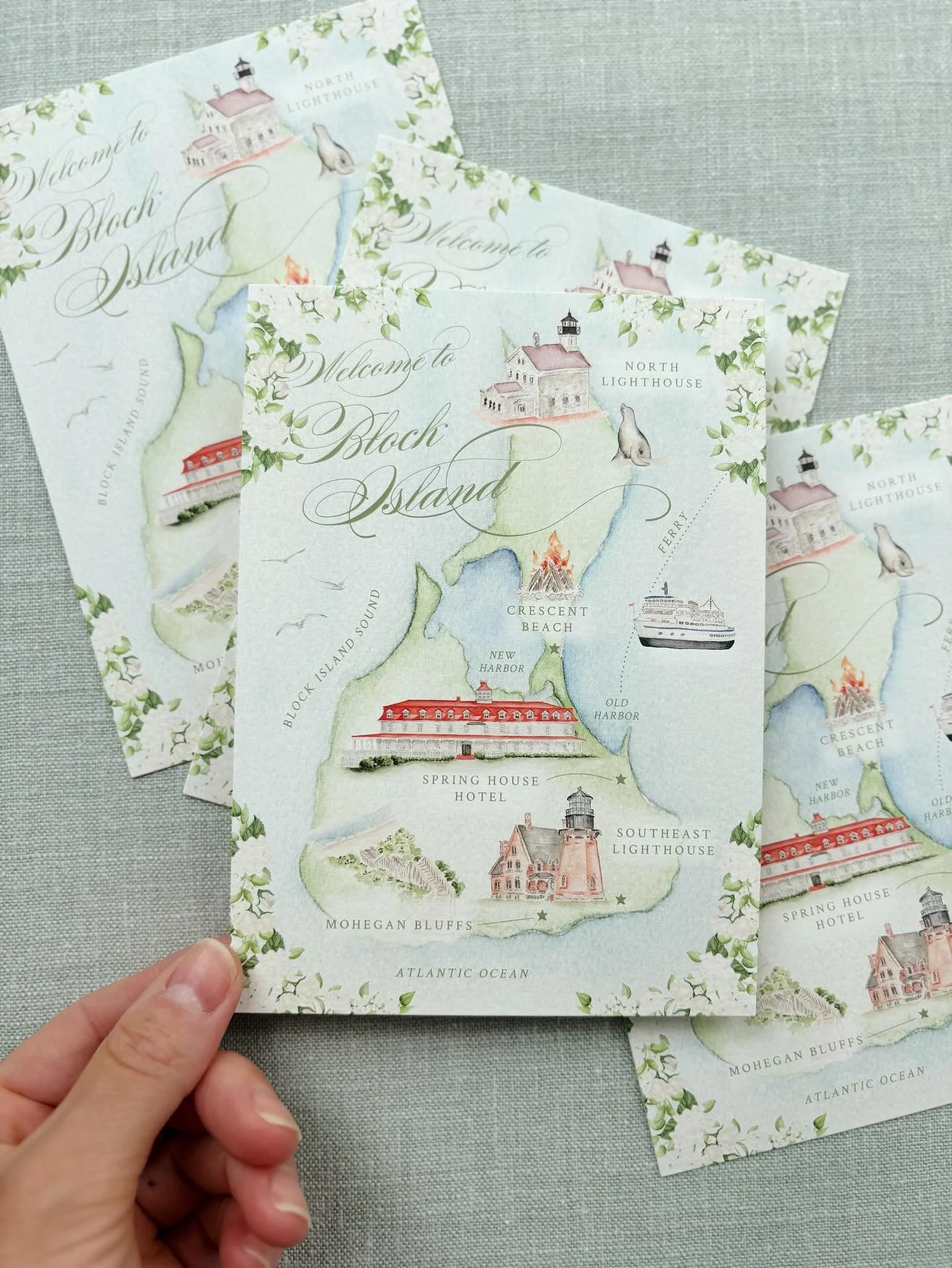 A warm watercolor wedding welcome to Block Island, featuring hand-painted landmarks of the North and Southeast Lighthouses, Spring House Hotel, Mohegan Bluffs and a few more cutie illustrations&mdash;perfectly capturing the charm of a coastal celebra
