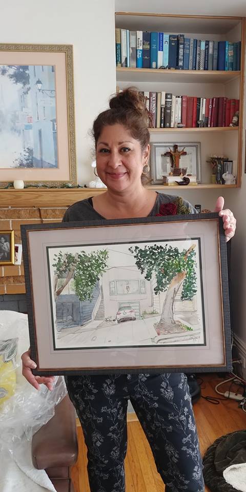 Mallory at home with a sketch of her home 