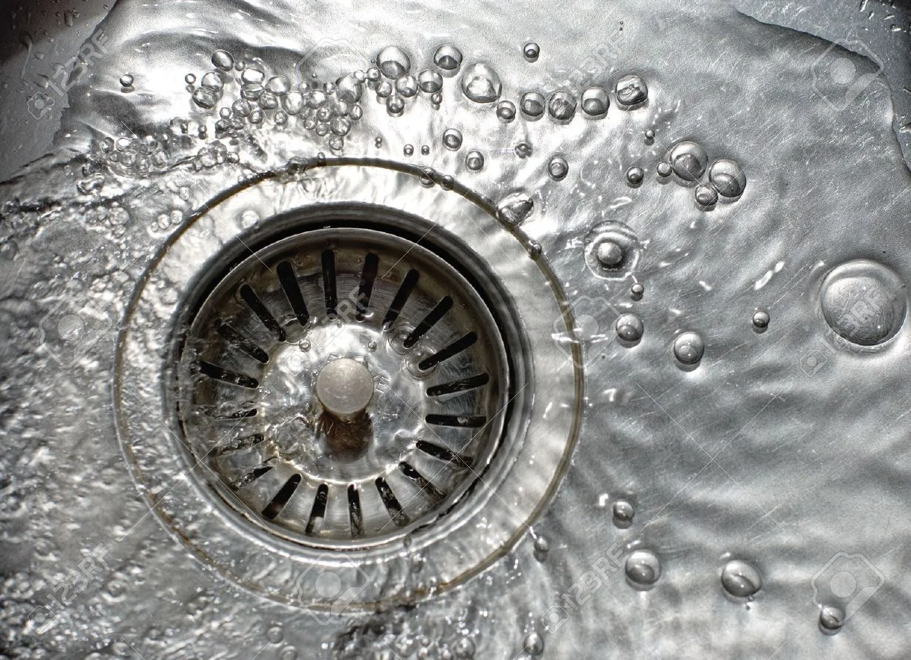 10360061-Close-up-of-kitchen-sink-with-water-drops-Stock-Photo-plumbing.jpg