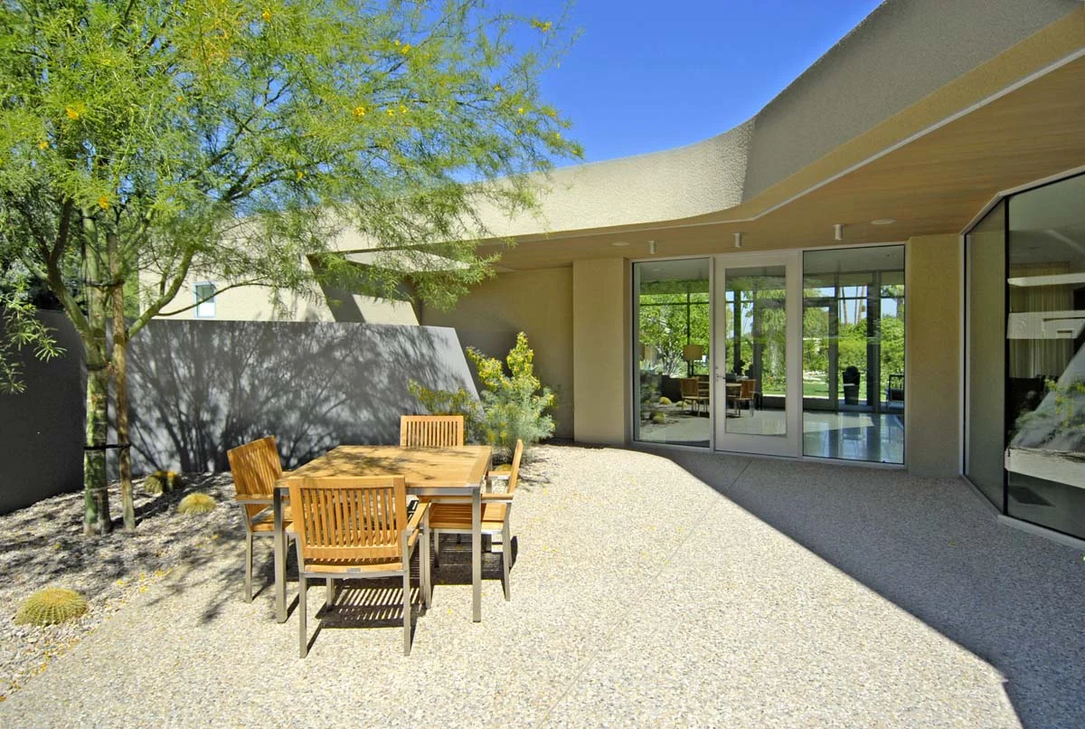 The clients for this desert retreat near Los Angeles requested that their weekend home be practical, indestructible, and beautiful. Minimal maintenance was an important factor in all decisions. A minimal choice of materials therefore seemed appropriate. With the exception of the carpeted bedrooms, all of the floors are the same white terrazzo tile. The walls are all the same color white; the three bathrooms have the same tiles, fixtures, and fittings. What sounds like a recipe for boredom instead has the opposite effect. The simple palette has the impression of making the home seem larger than it really is: the overall feeling is one of calm repose.
