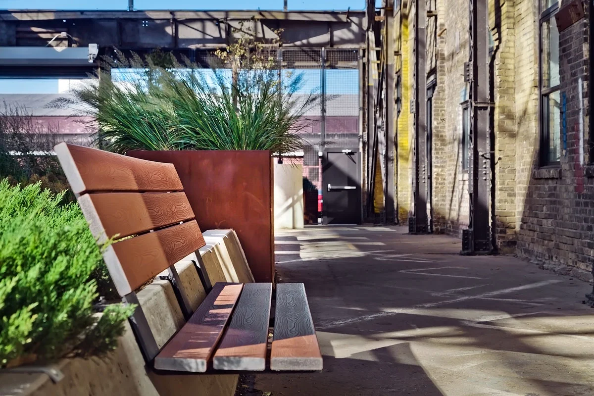 The sloped concrete planter walls become the foundation for comfortable, integral benches.