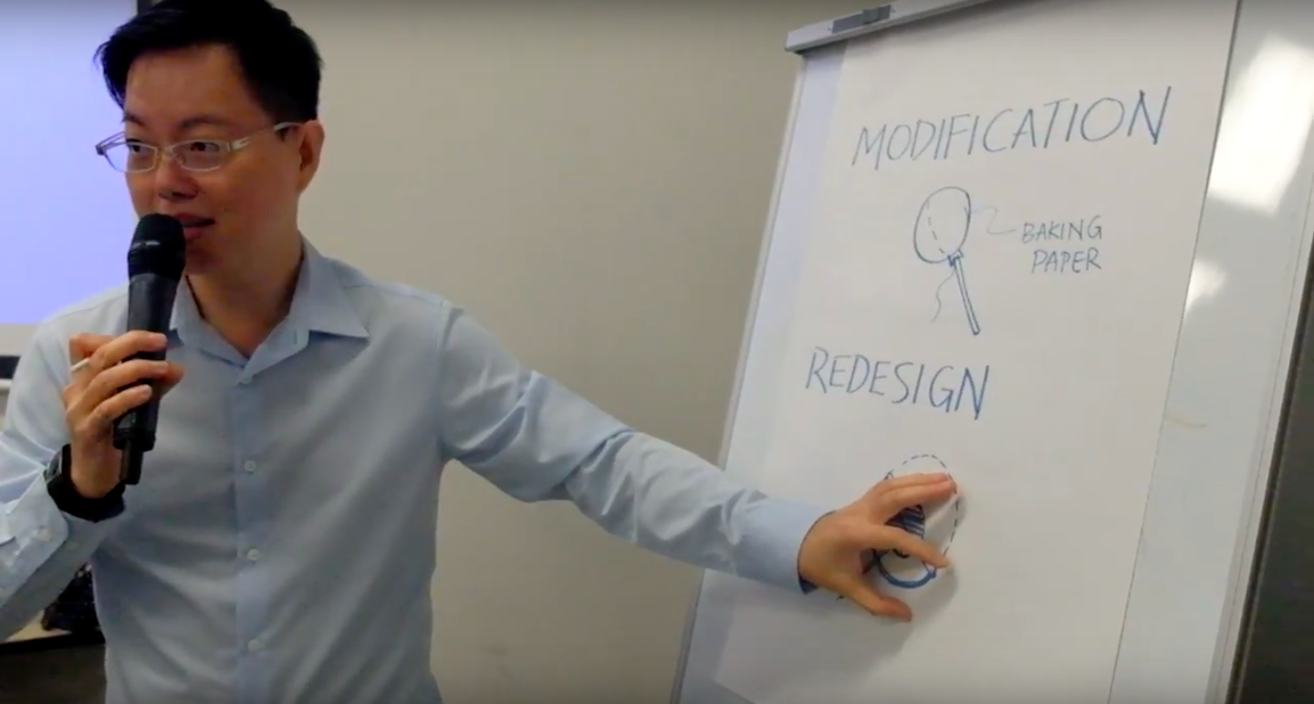 A workshop participant explaining his proposed re-design of the classic Chupa Chups Lollipop to enable greater accessibility for people suffering from muscular dystrophy.