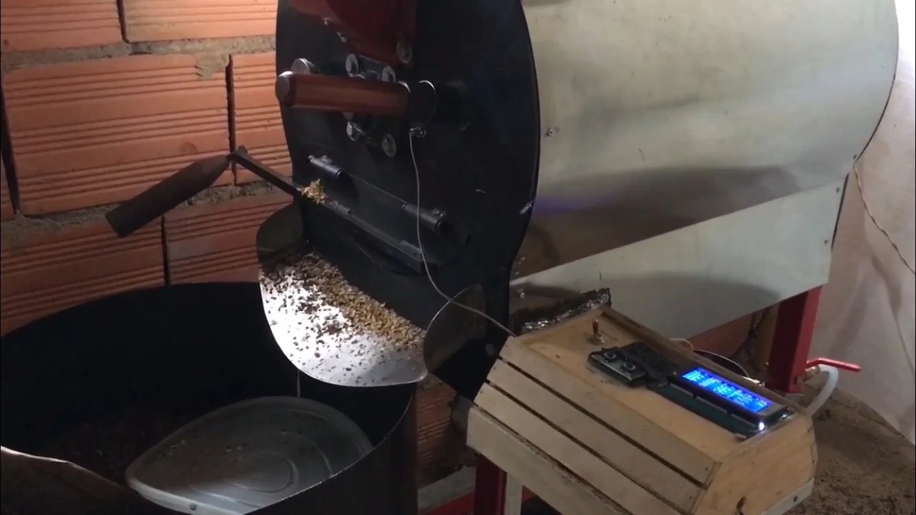 Roasted beans are collected in the black pot. Photo credit: Rubez Chong
