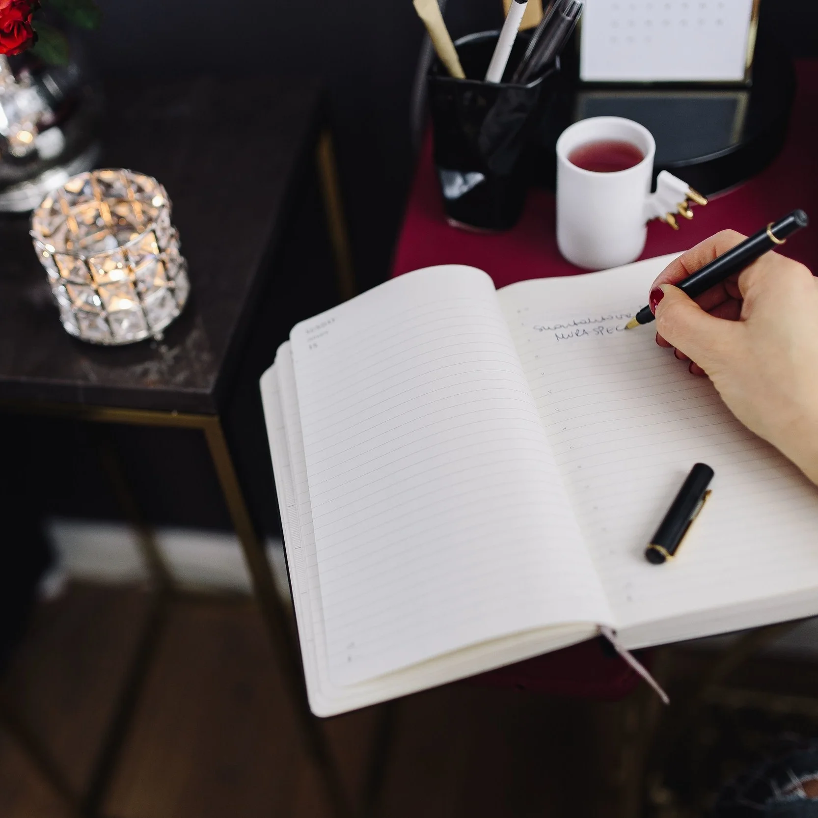 kaboompics_Woman writing on notebook.jpg