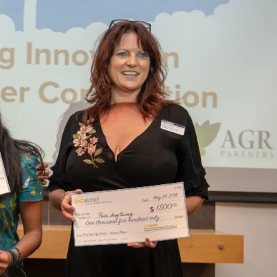 SEA Board Emeritus/Alumna Niki Peterson accepts the Food+Ag Innovation Poster & Pitch Competition award on behalf of Pair Anything .