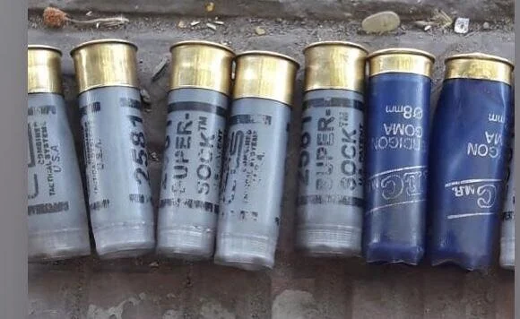  On the right are more blue shells. On the left are spent hulls of beanbag rounds. 