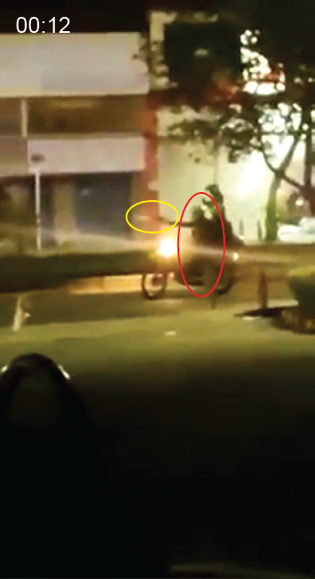  A police officer on motorcycle (red circle) stops and fires a single shot from a handgun (yellow circle) at an unknown target off-screen. Muzzle blast is visible in this frame. 