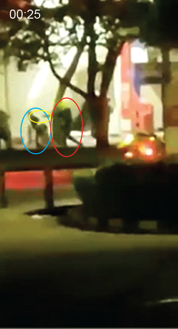  As civilians flee in multiple directions, a police officer (red circle) chases a civilian (blue circle) while pointing a handgun (yellow circle). 