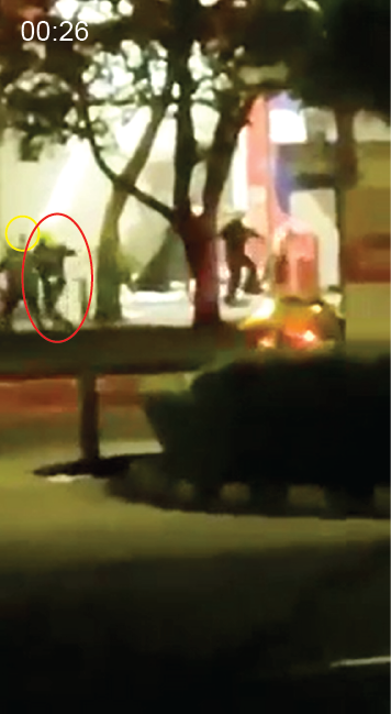  As the victim moves off-screen, the handgun is visible in the right hand of the officer. Seconds later, the officer is seen kicking another shooting victim on the ground. 