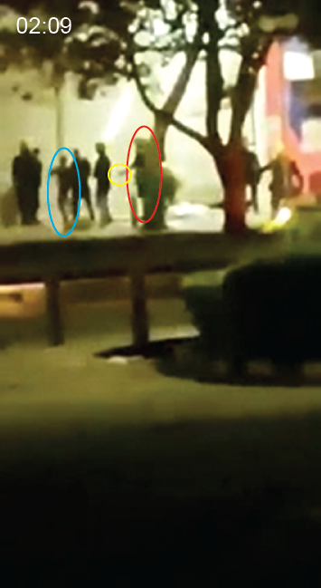  The presumptive handgun is visible as one of the detainees collapses. The detainee is later seen running off screen to the right; the police do not pursue. 