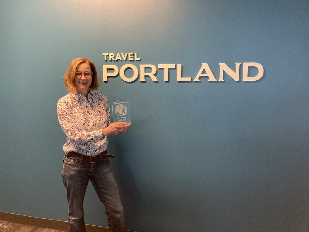  Billie Moser, Vice President, International Tourism, proudly displays Travel Portland’s Celebrate Trade Award. 