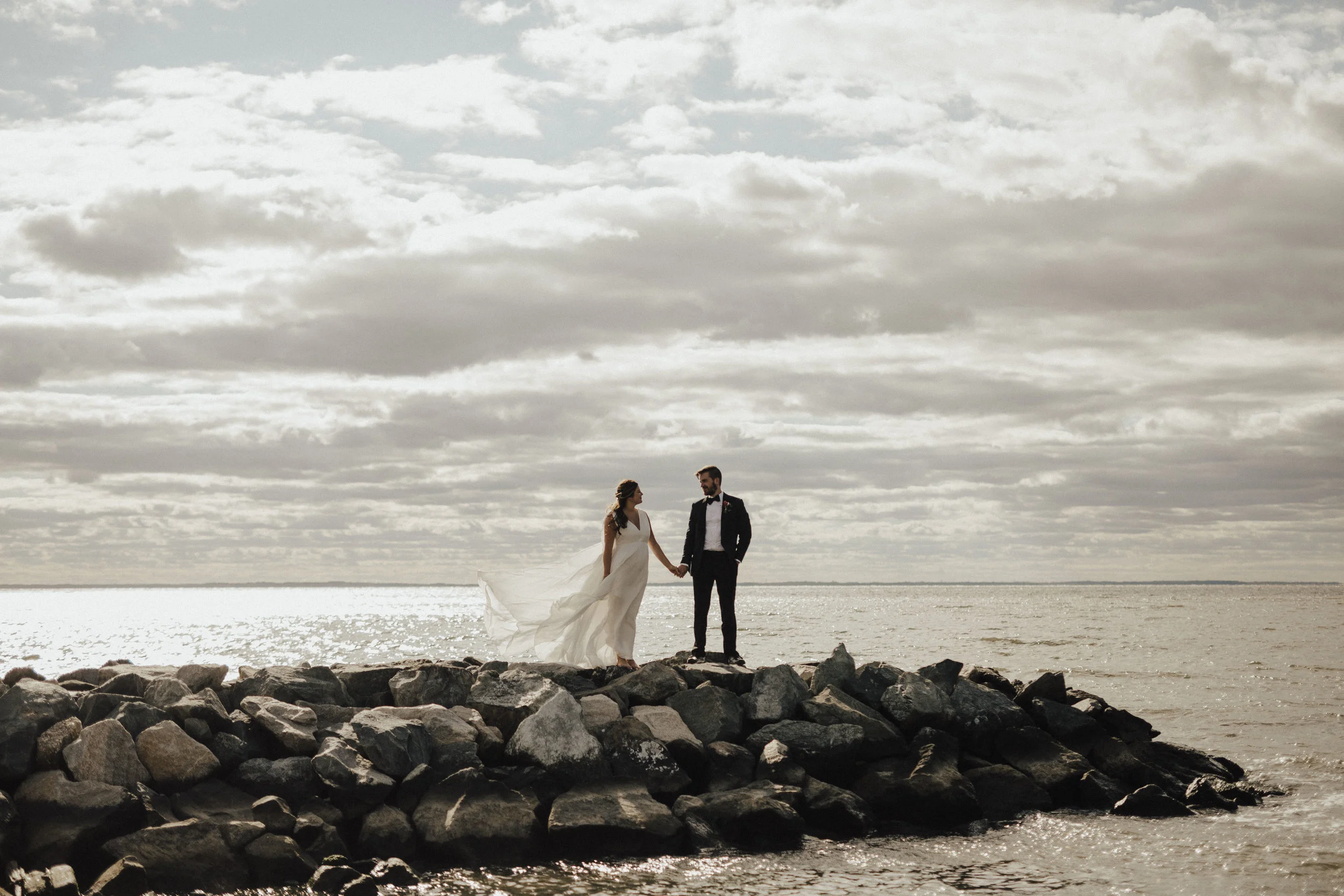 Jenn & Chase wanted their wedding to feel unique and personal, and the Haven Harbour Inn & Marina quickly became the perfect backdrop. From the hand-made altar Chase and his father built, to the shot of whiskey during the unity ceremony led by Chase's grandmother, the day was truly their own. Large, tropical leaves adorned the reception tables, surrounded by vintage hurricane candle holders. The couple had oysters from the Chesapeake Bay, as well as their favorite pizza truck, Timber Pizza Co, cater the evening. A close friend DJ'ed the event and had guests on the dance floor all night long. 