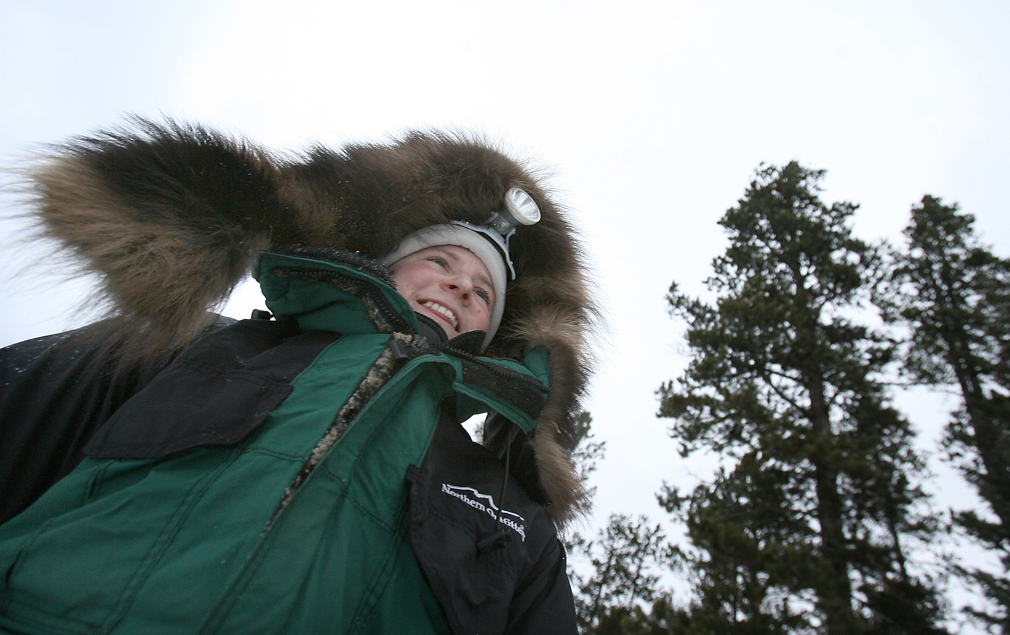 Decked out in cold-weather gear and a headlamp, Daugereau sets out on a training run in Montana. She made the collar on her parka from Wolverine fur.