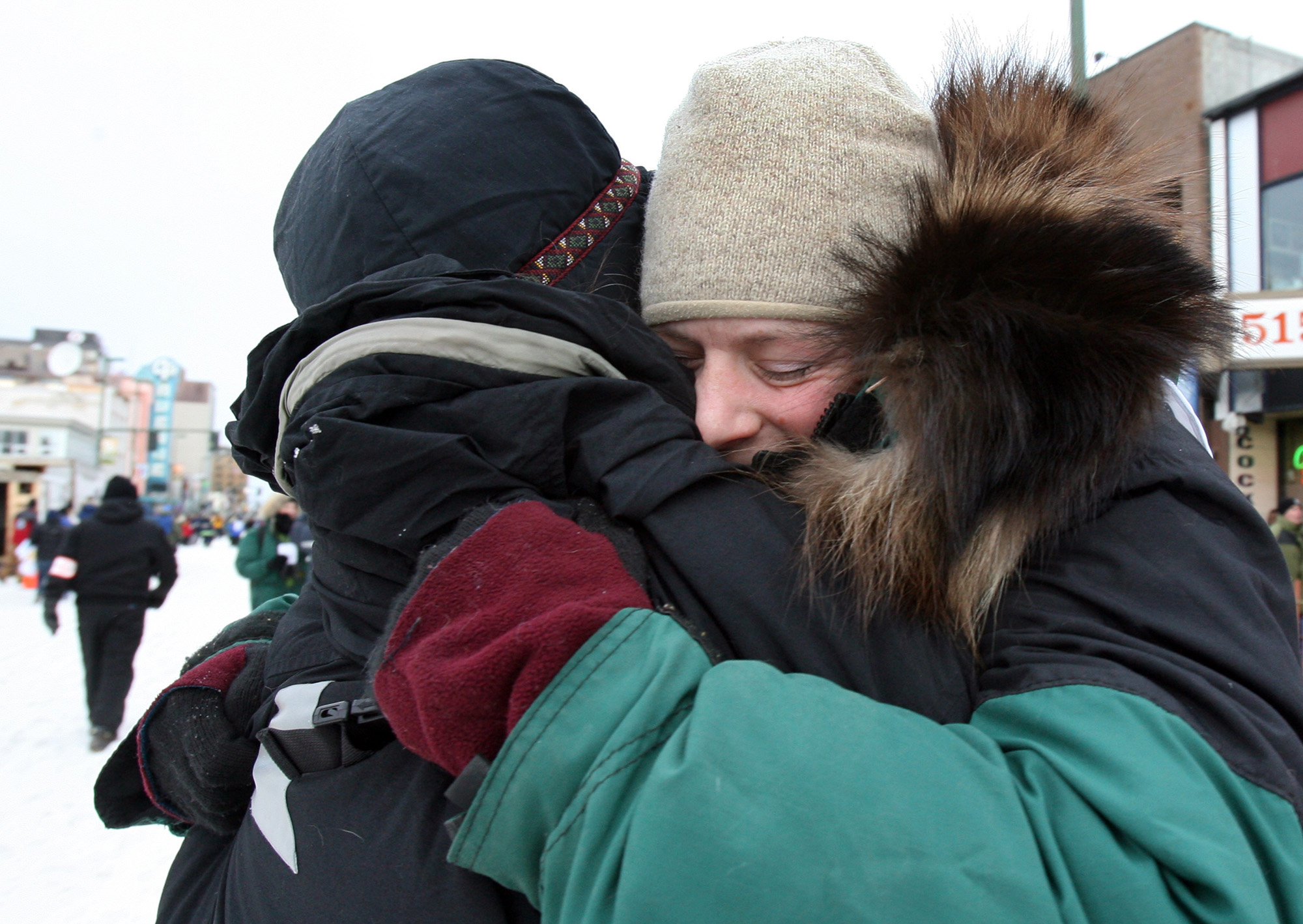 Laura Daugereau takes a quiet moment away from the crowd at the unofficial start of the Iditarod to hug her mother, Carol Daugereau. "We're here," the younger Daugereau whispered in her mother’s ear, "See you in Nome!"