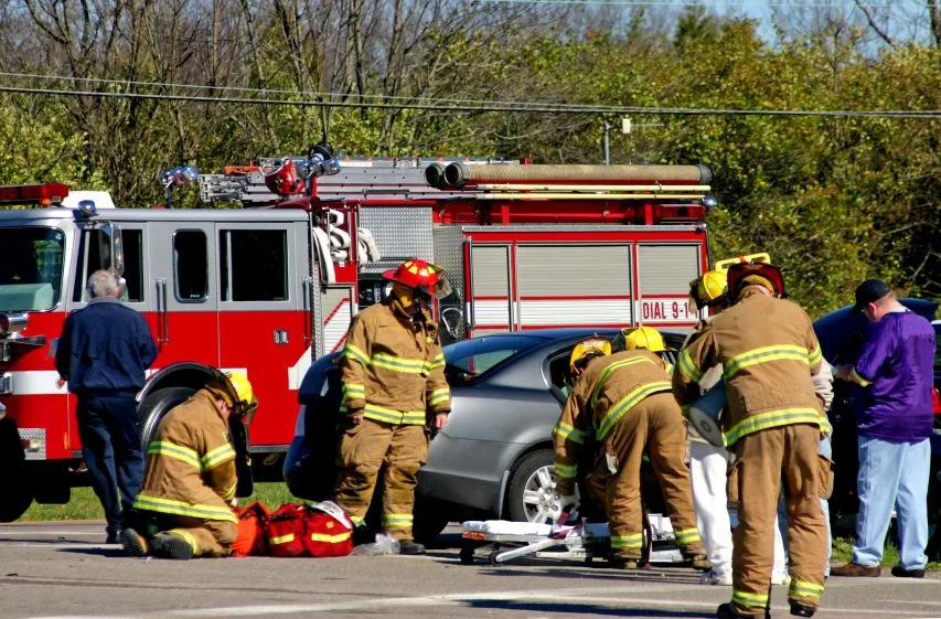 A car crash victim being helped by firemen needs assistance from Marietta personal injury lawyers.