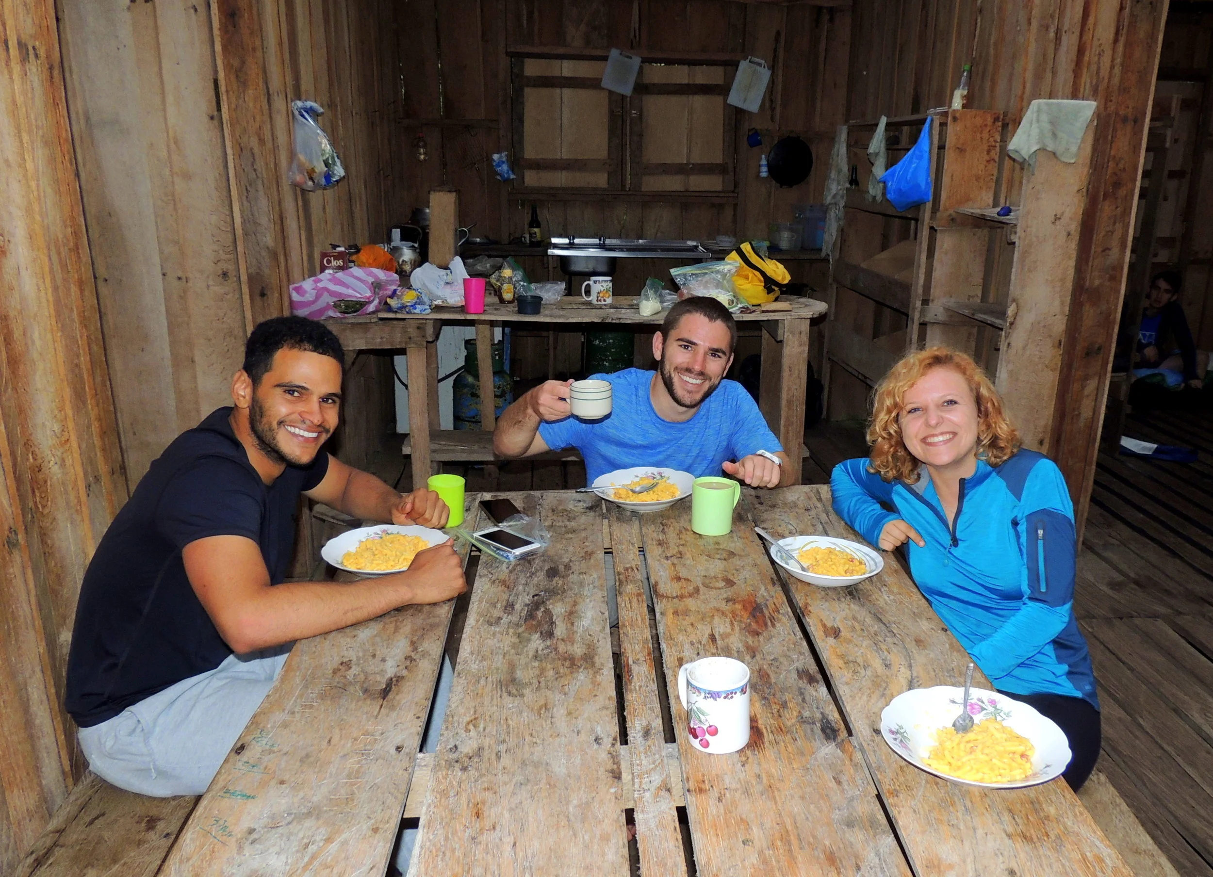 (L-R) Abner Rodriguez, Steven Blankenship, and Amy Eppert eat a well-earned dinner of Mac 'n' Cheese with salchichon (sausage) at Valle de Silencio.