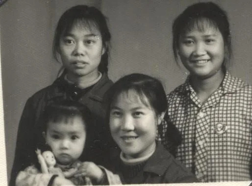 Jennifer’s mother, her two friends and two-year-old Jennifer. As the first child in the family, Jennifer enjoyed some “special” treatment such as having a doll of her own. After her two younger sisters were born, her parents no longer had the ability to buy more dolls for her sisters. (Provided by Jennifer Zeng)