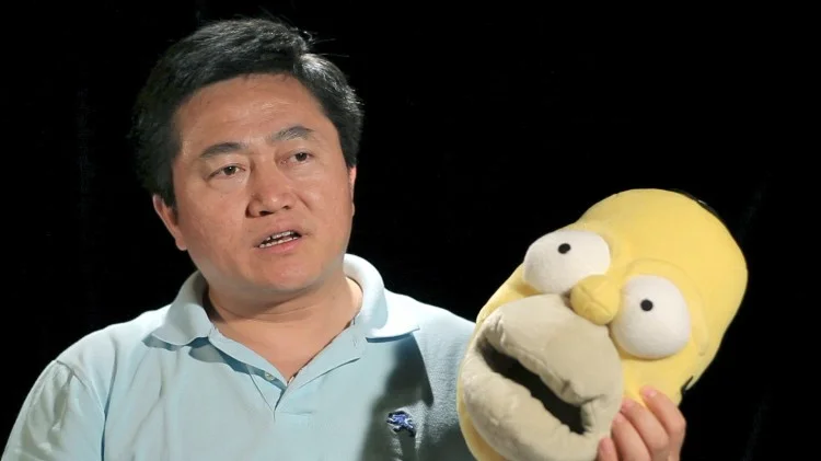 Charles Lee shows a pair of “Homer Simpson” slippers like the ones he made while incarcerated in a Chinese labour camp. (Courtesy NTD Television)