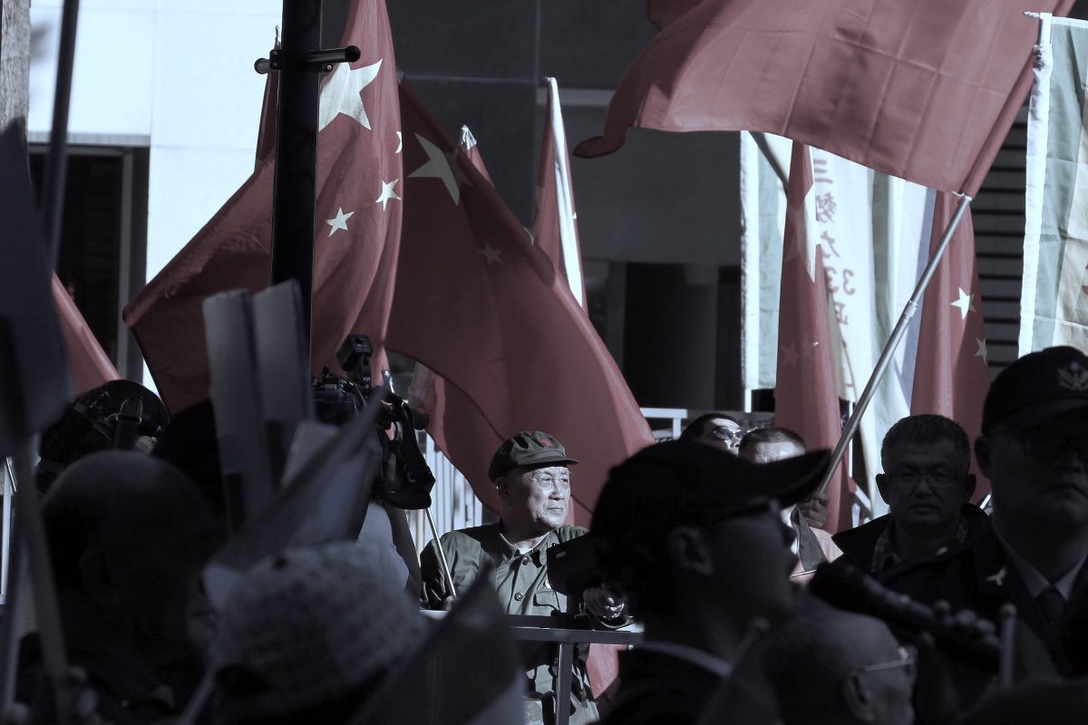 A pro-China demonstrator waves a Chinese flag outside where the Twin City Forum is being held in Taipei on Dec. 20, 2018. (HSU TSUN-HSU/AFP/Getty Images)