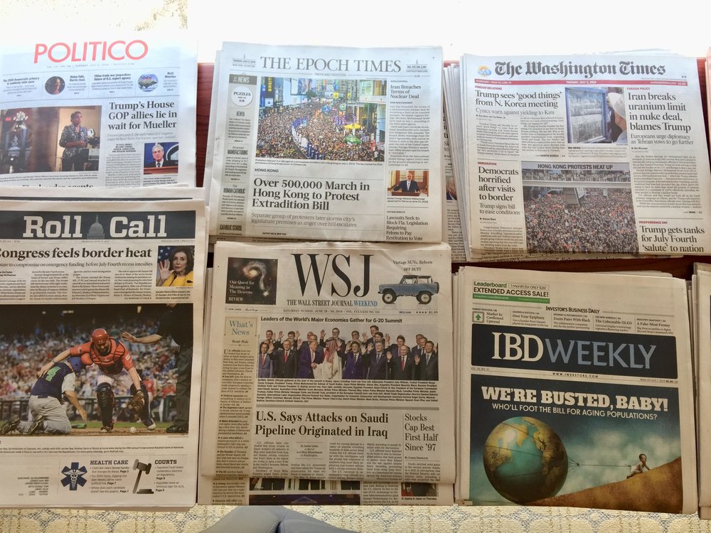 Front pages of different English language newspapers display at the National Press Club on July 2, 2019