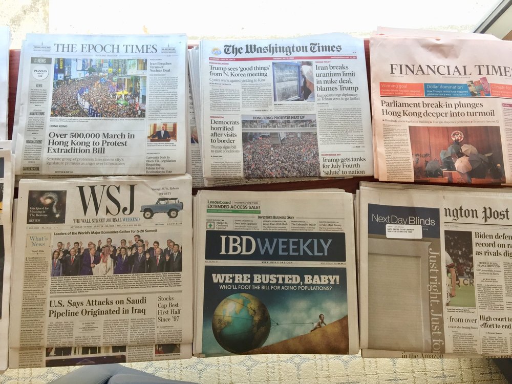 Front pages of different English language newspapers display at the National Press Club on July 2, 2019