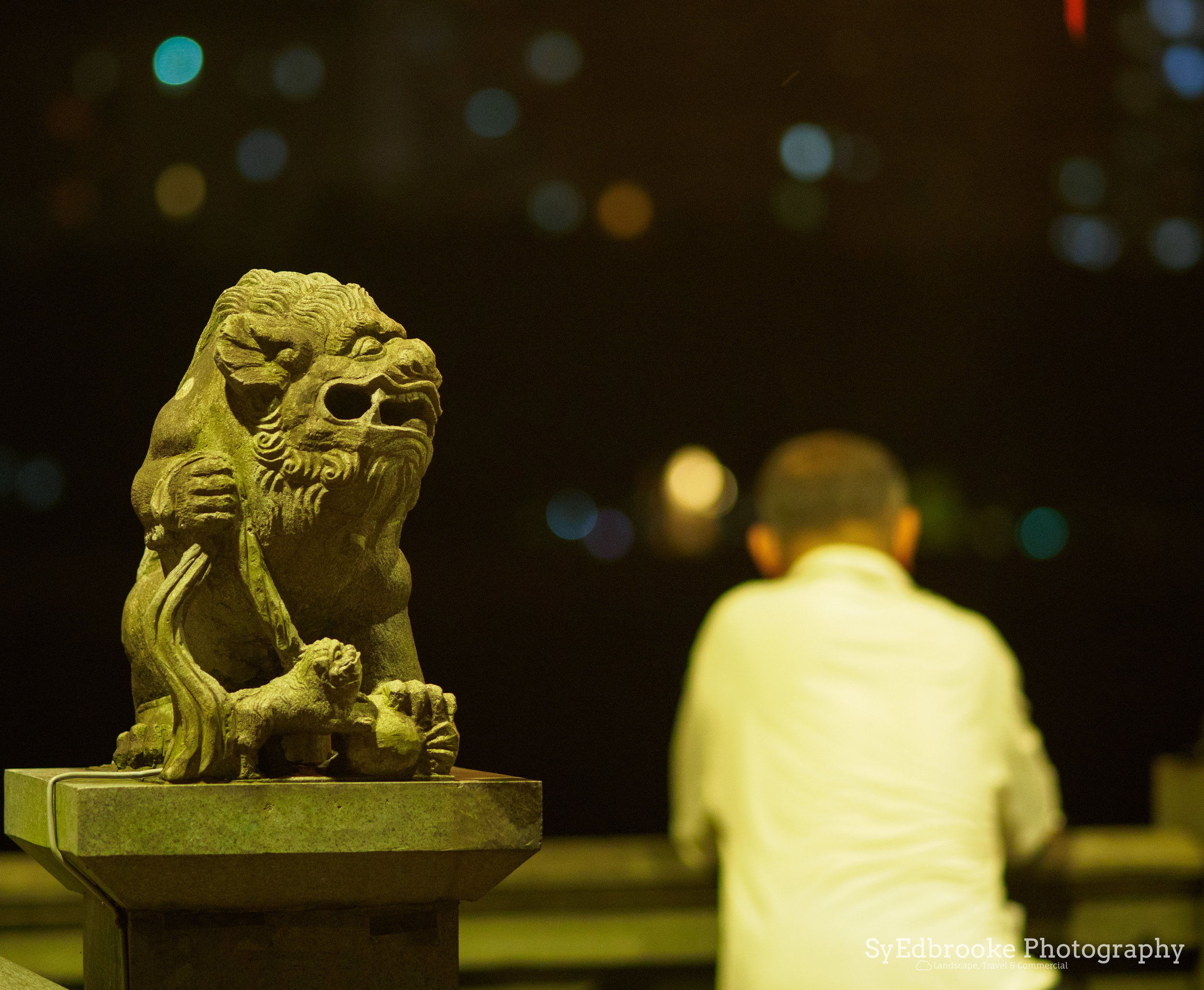 A local relaxing on a hot summer night. f1.8, ISO 1600, 1/30, 17mm