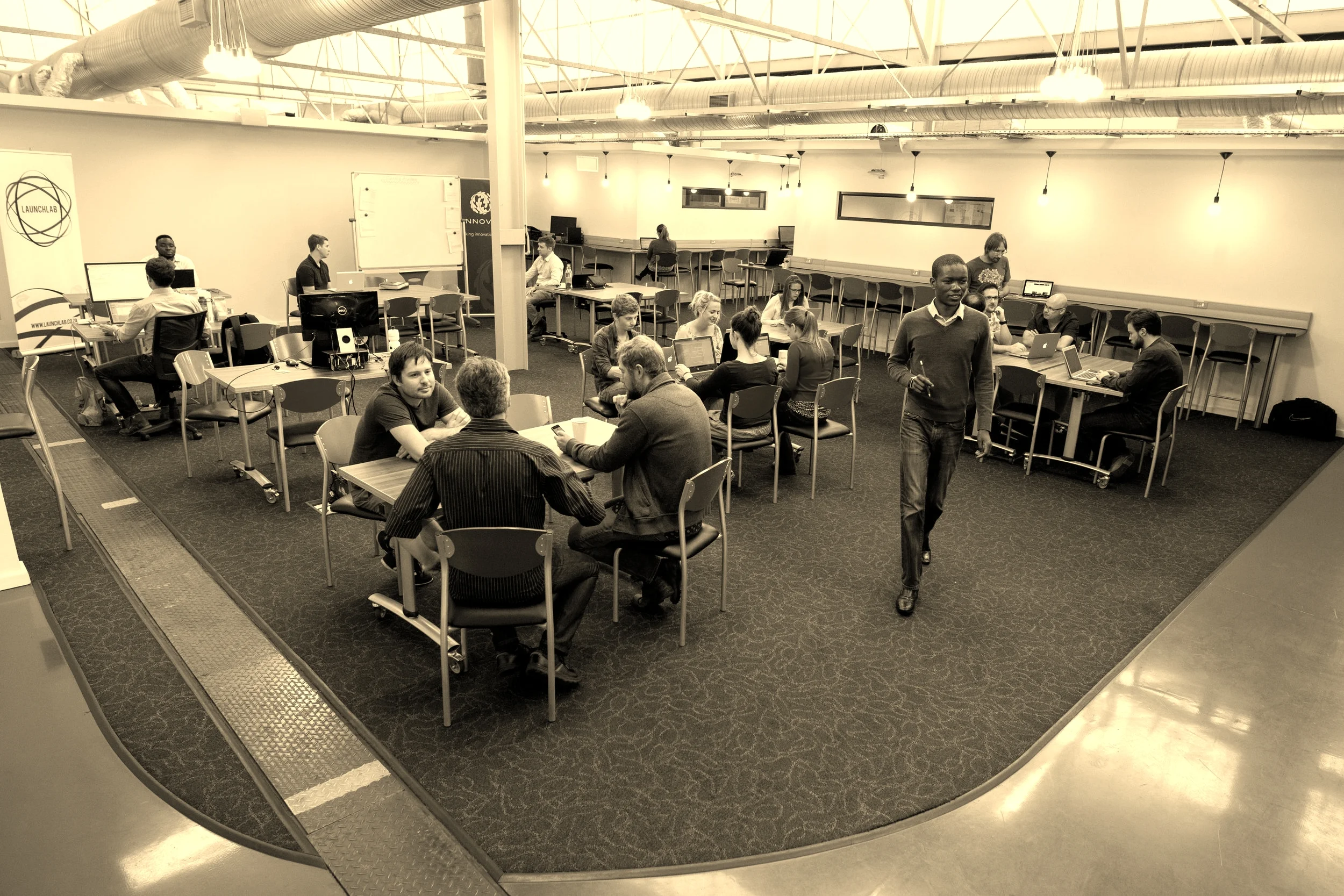 LaunchLab hotdesk area with members working with each other