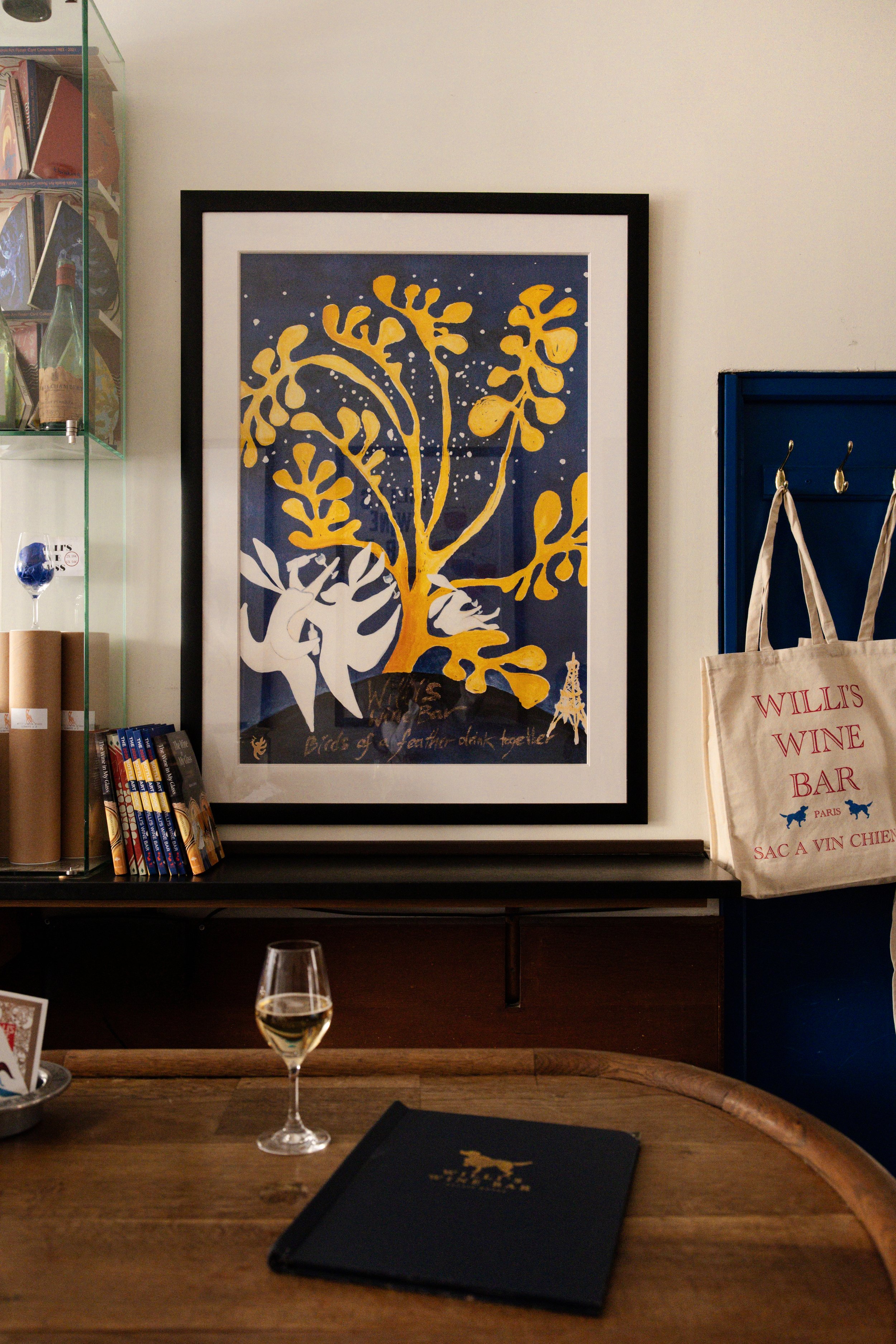Willi's Bottle Art poster showing white rabbits dancing on a blue background with a yellow Matisse-inspired tree
