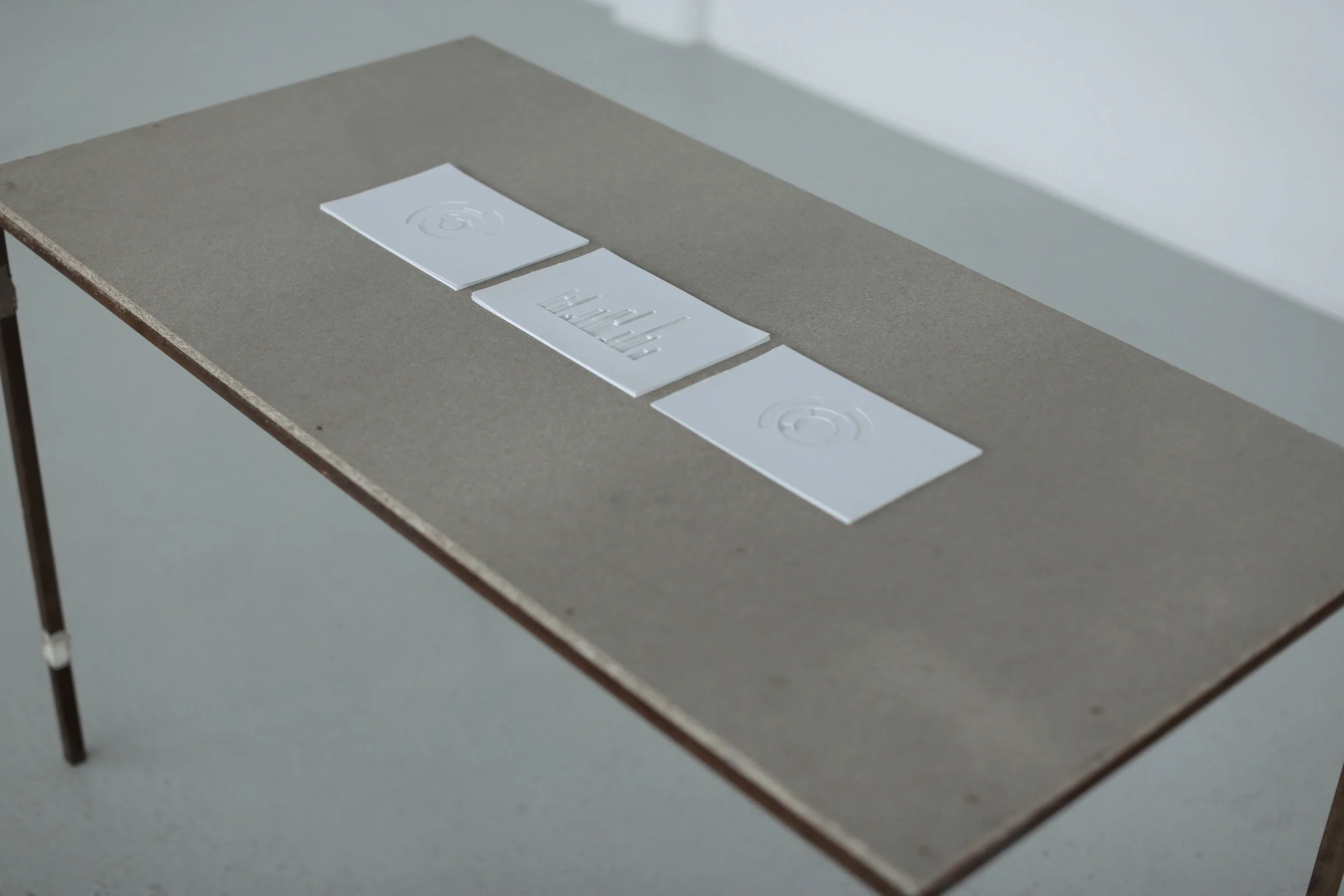  A meticulous, comparative, visual, statistical representation of vast volumes of data, retrieved from crucial archival documents and from personal memory and knowledge. (Selection of three). Installation of cut carton on wooden table. 1480 x 600 x 7