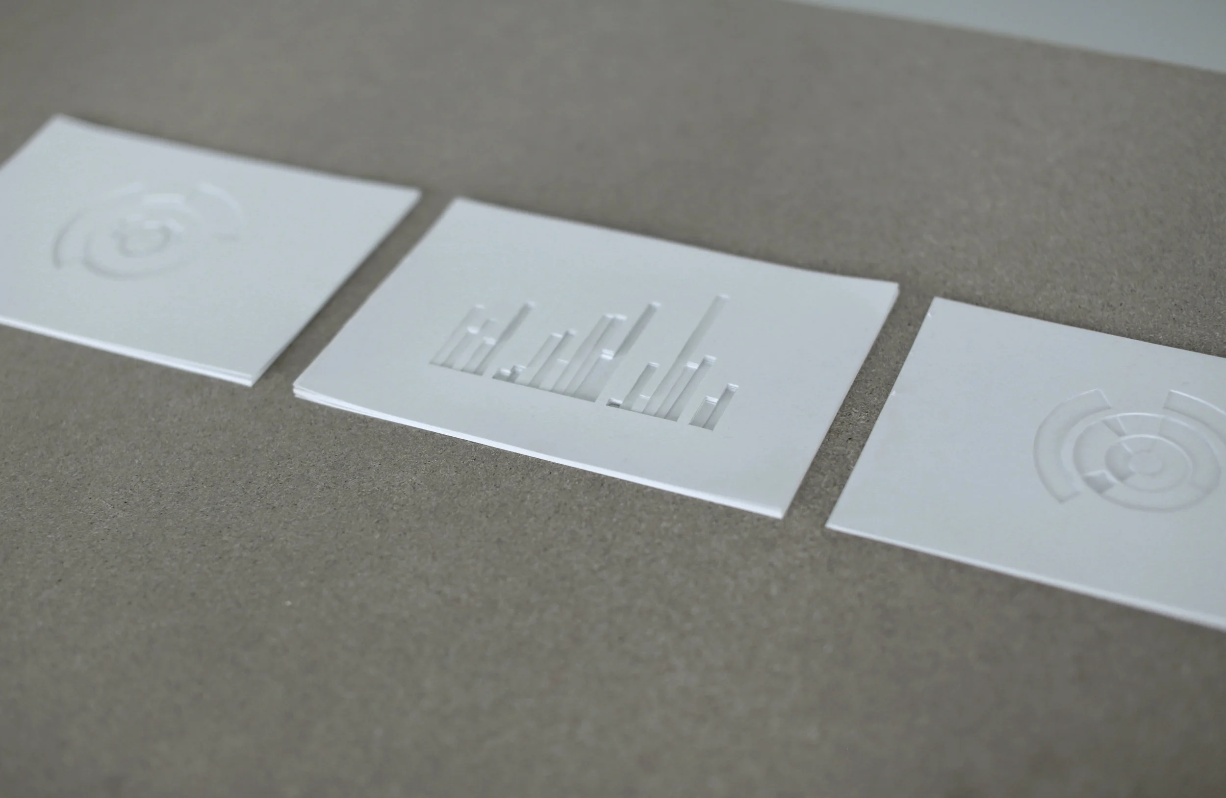  A meticulous, comparative, visual, statistical representation of vast volumes of data, retrieved from crucial archival documents and from personal memory and knowledge. (Selection of three). Installation of cut carton on wooden table. 1480 x 600 x 7