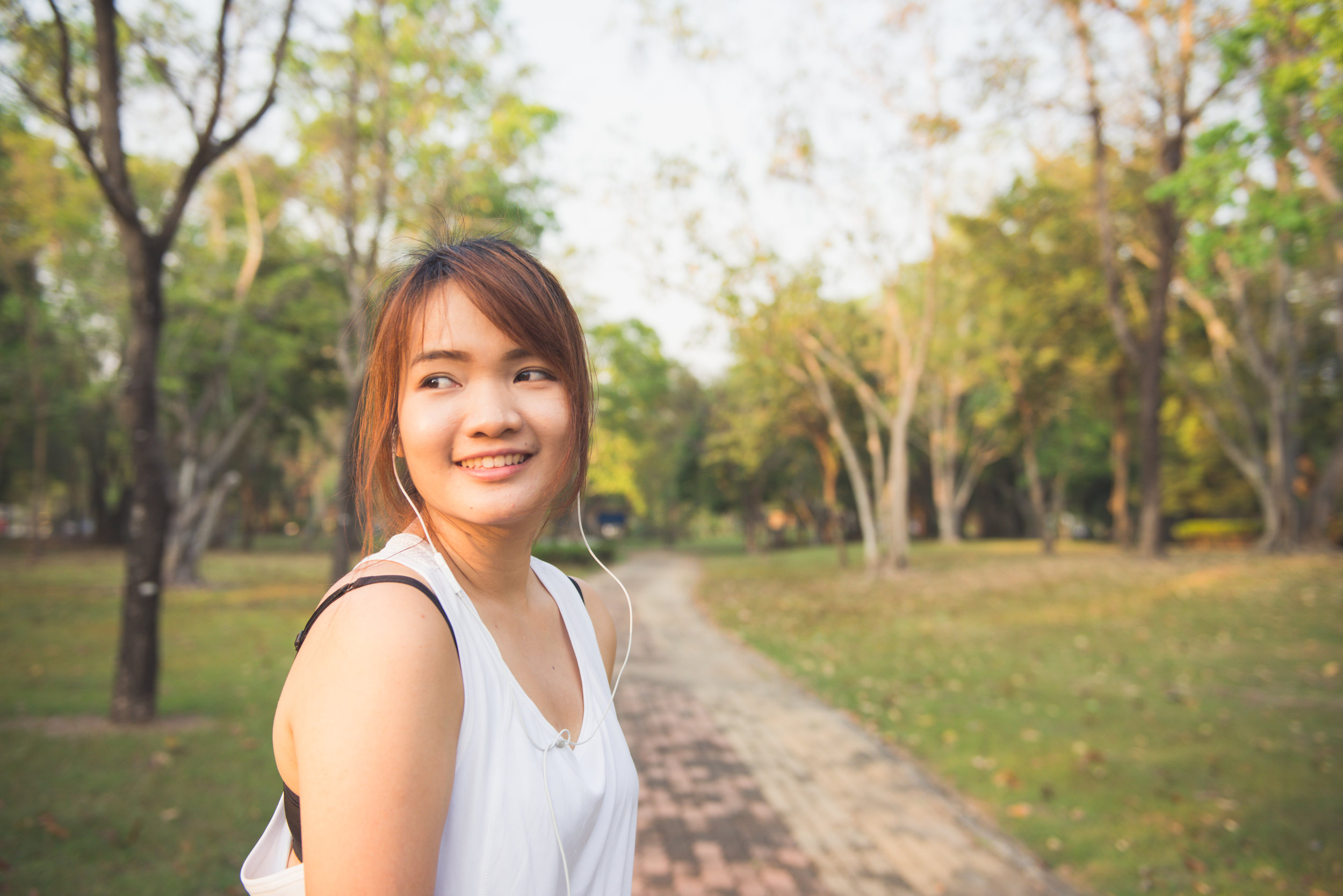 woman-listening-smiling-park.jpeg