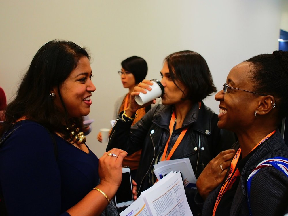Participants mingling in the hallways between sessions