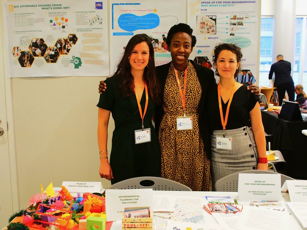  DivComm members Kate Selden, Daphne Lundi, and Ciera Duddley at the youth education and planning showcase, featuring the various activities used for DivComm workshops to introduce young people to urban planning.  