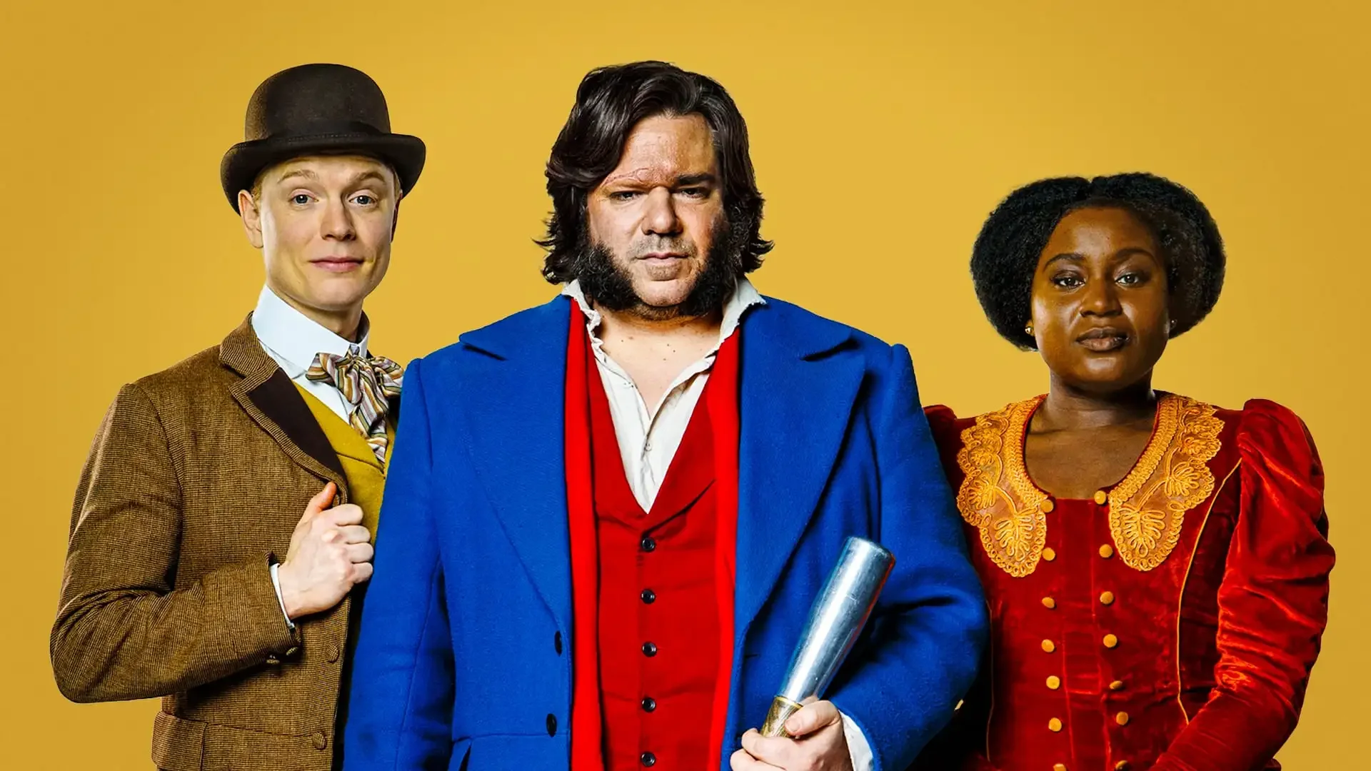 Three diverse actors in period costumes from the TV series 'Our Flag Means Death' standing against a yellow background. The man in the middle holds a rolled document, with the woman on the right wearing a red and gold dress, and the man on the left in a brown suit and bowler hat.
