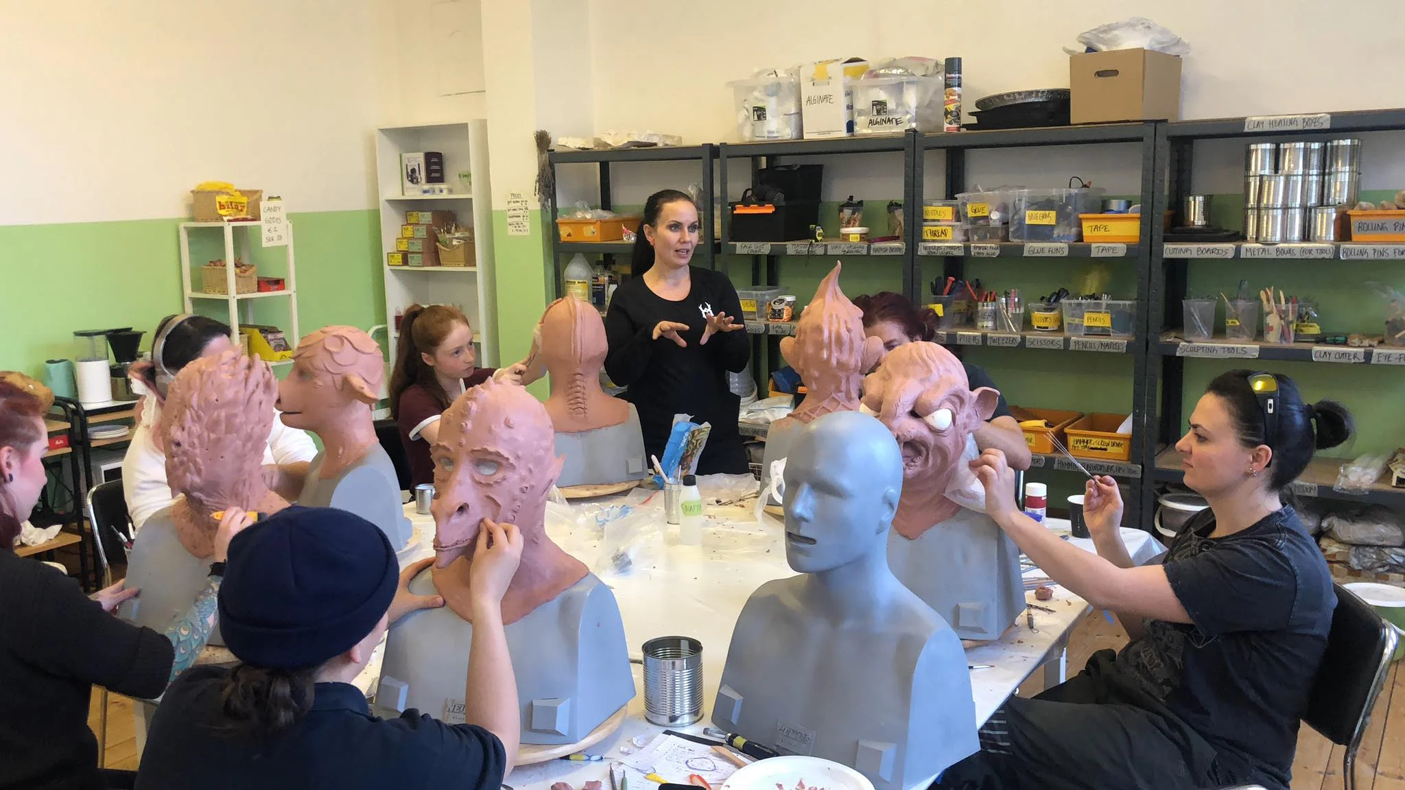 Students learning how to sculpt their fantasy creatures in clay during our 10-day mask making workshop
