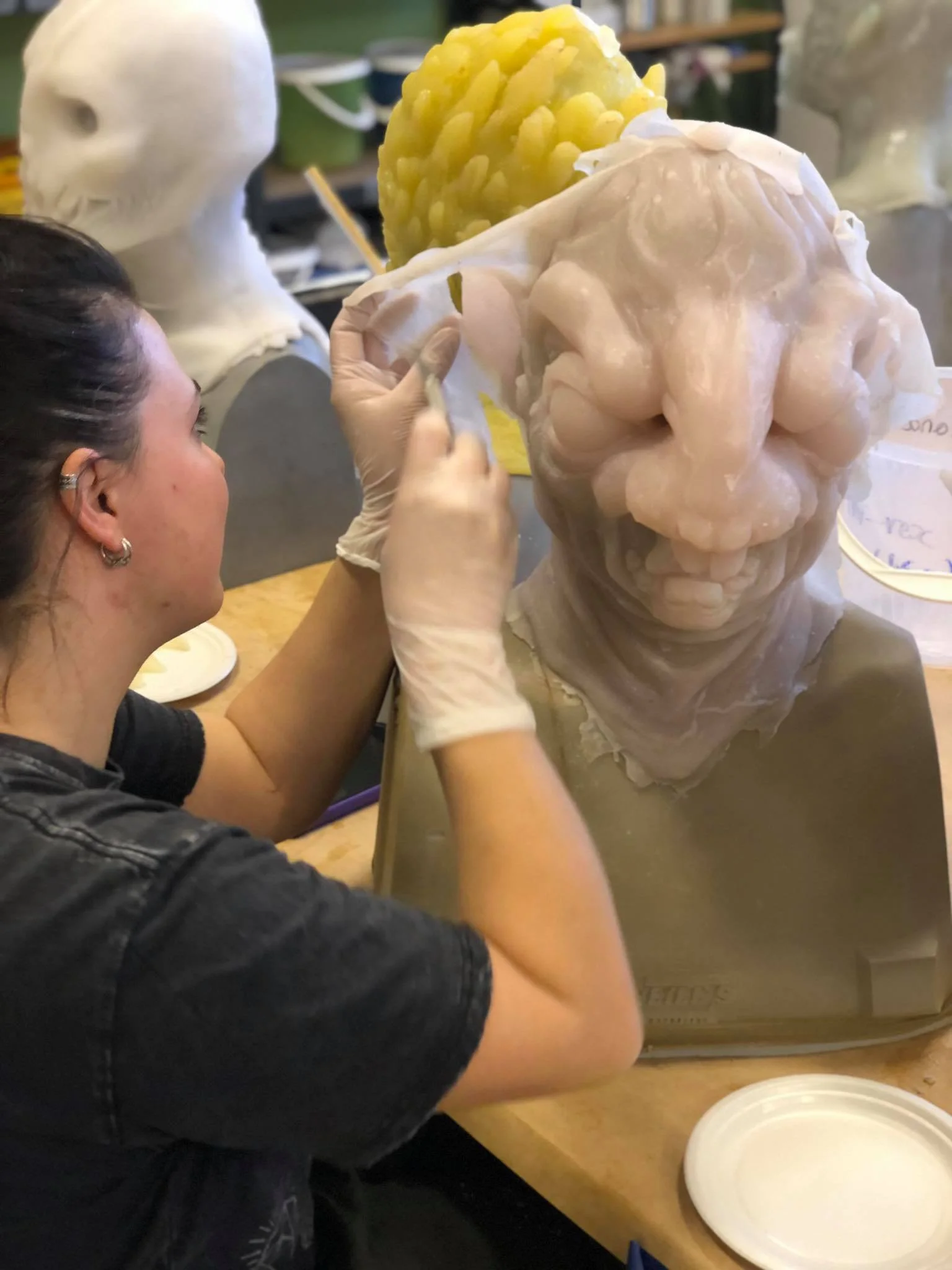 The cast of a mask in silicone straight out of the mold. Time to clean up the seam before painting.