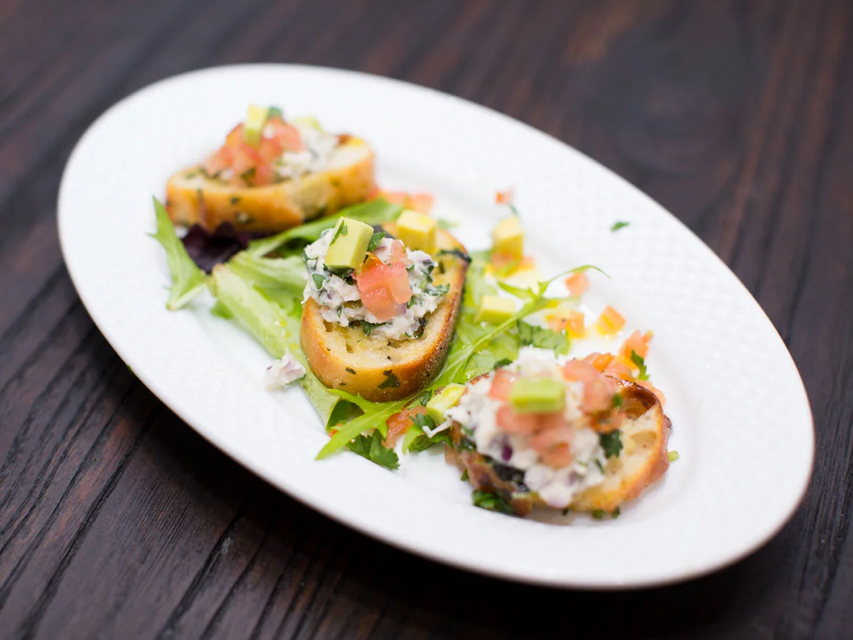 Crab & Avacado salad on garlic herbed Crustini with lemon jalapeño vinaigrette.