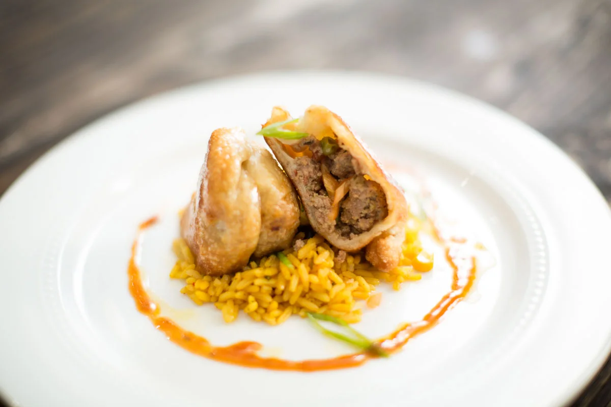 Turkey Empanadas over Sofrito rice with Tamarind glaze 