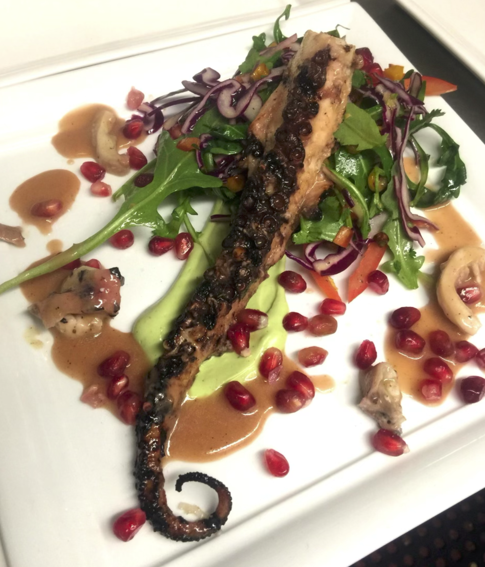 Grilled octopus with pomegranate mixed green salad 