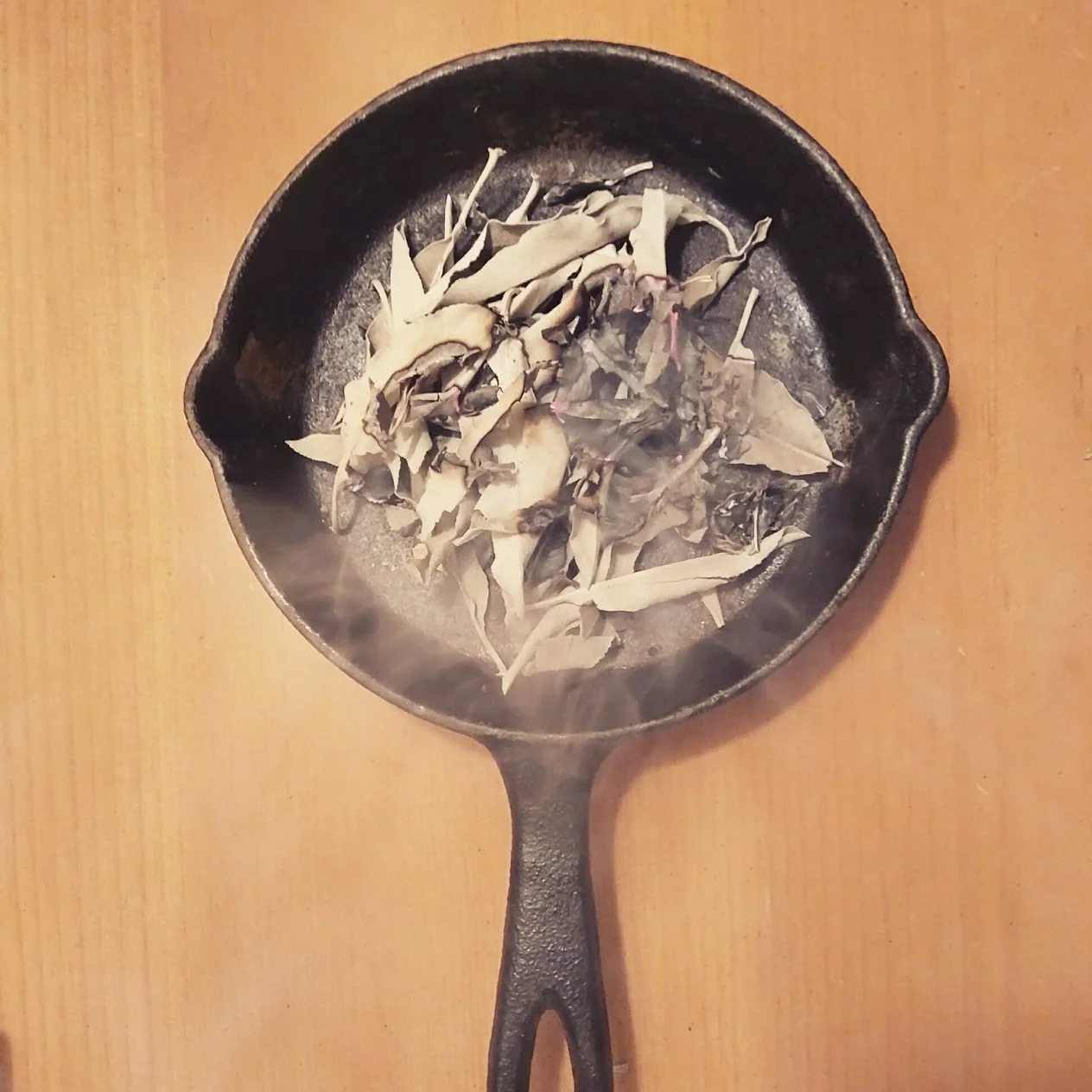 burning sage in cast iron pan