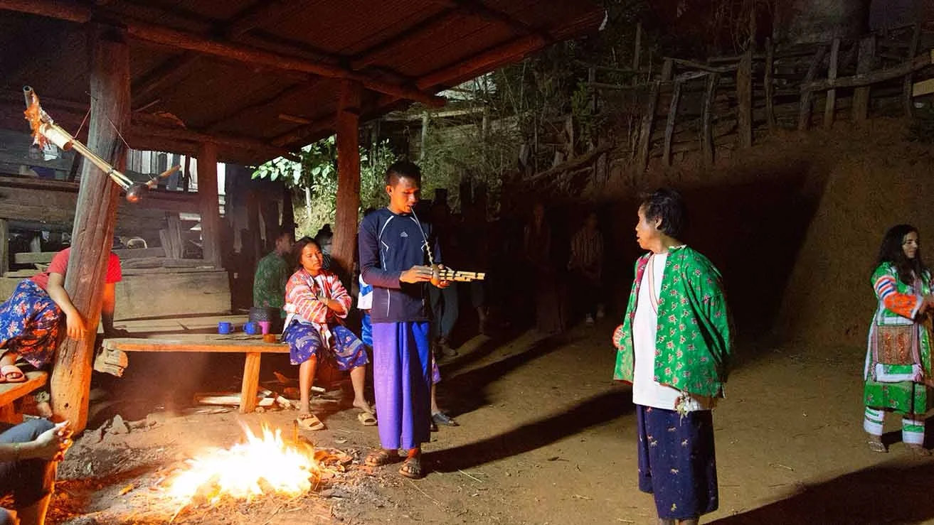 Lahu ceremony in the Dancing Circle, picturing the traditional flute-like instrument to which the dances were set. Also featuring traditional Lahu clothing, which many of us foreigners started wearing by the end of our stay.